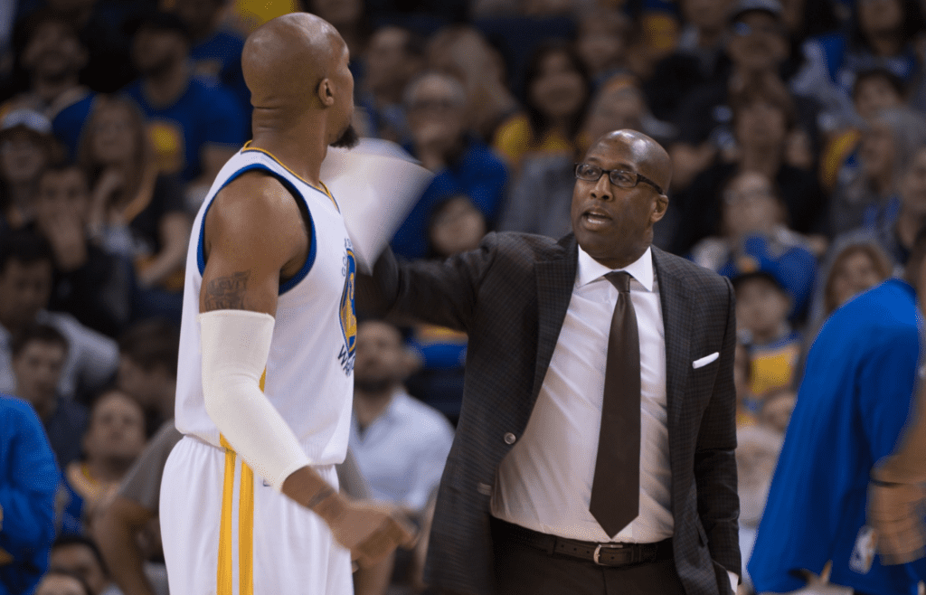 Golden State Warriors assistant coach Mike Brown (right) instructs forward David West (3) during the fourth quarter against the Denver Nuggets at Oracle Arena. The Warriors defeated the Nuggets 127-119