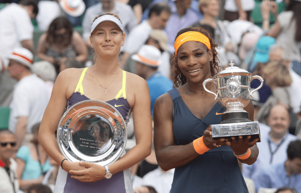 Serena Williams (USA), right, and Maria Sharapova (RUS) pose with their trophies after their match on day 14 of the 2013 French Open at Roland Garros