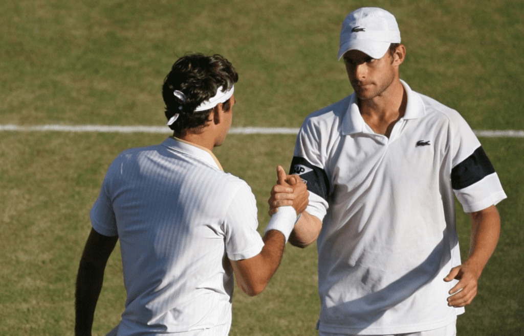 Roger Federer (SUI) (left) greets Andy Roddick (USA) after Federer won the mens' singles final round 2009 Wimbledon Championships at the All England Lawn Tennis Club. Federer won 5-7, 7-6 (6), 7-6 (5), 3-6, 16-14. It was his record-breaking 15th major championship