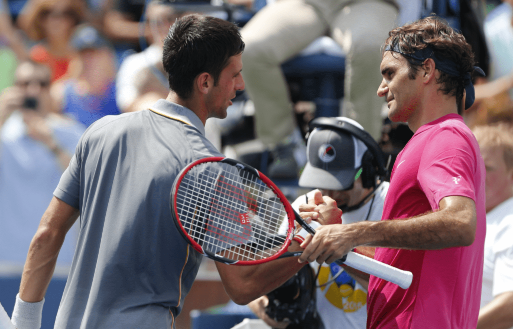 Novak Djokovic (left) shakes hands with Roger Federer (SUI) after their match in the finals during the Western and Southern Open tennis tournament at the Linder Family Tennis Center