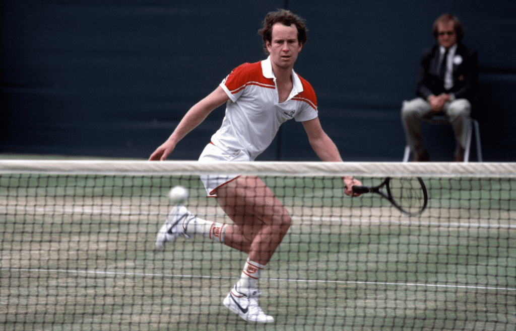 John McEnroe (USA) comes to the net and prepares to return a shot during the 1983 Wimbledon Championships at the All England Lawn Tennis Club