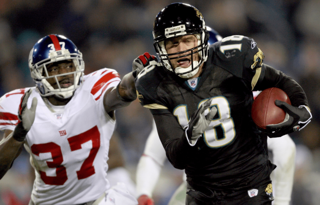 Nov 20, 2006; Jacksonville, FL, USA; Jacksonville Jaguars wide receiver (18) Matt Jones runs away from New York Giants safety (37) James Butler after a catch during the 4th quarter at Alltel Stadium in Jacksonville, Florida. Jaguars defeated the Giants 26-10. Mandatory Credit: Jason Parkhurst-Imagn Images Copyright © 2006 Jason Parkhurst