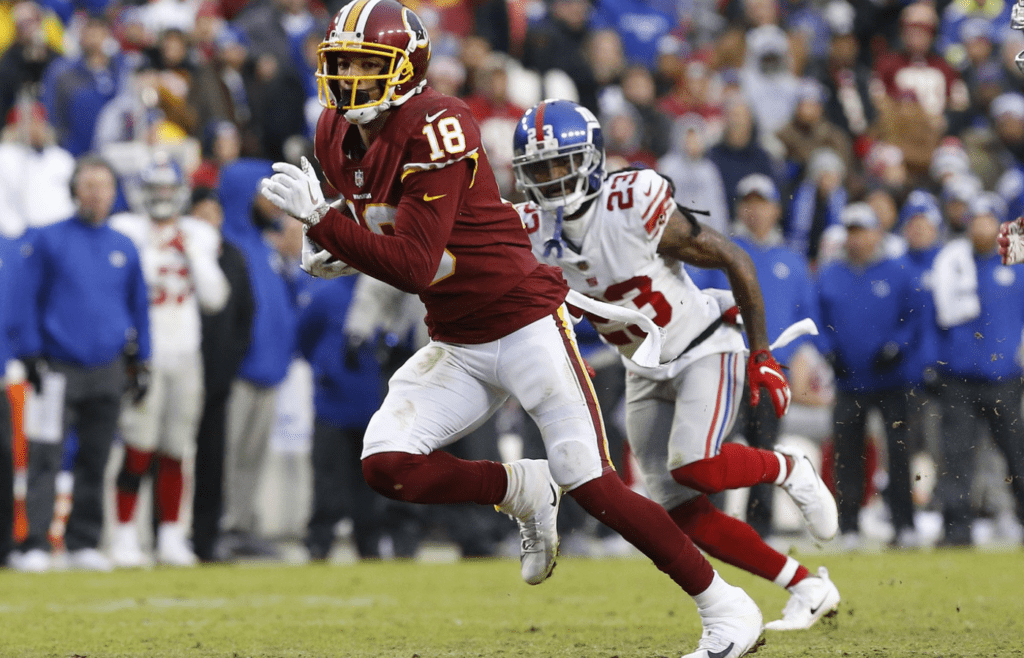 Dec 9, 2018; Landover, MD, USA; Washington Redskins wide receiver Josh Doctson (18) runs with the ball past New York Giants cornerback B.W. Webb (23) in the fourth quarter at FedEx Field. The Giants won 40-16. Mandatory Credit: Geoff Burke-Imagn Images