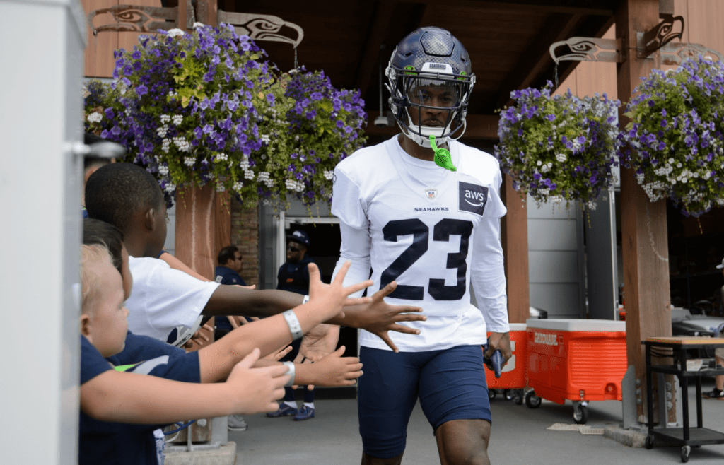Jul 30, 2023; Renton, WA, USA; Seattle Seahawks cornerback Artie Burns (23) interacts with fans prior to training camp at the Virginia Mason Athletic Center. Mandatory Credit: Steven Bisig-Imagn Images