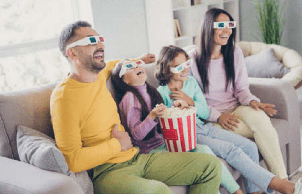 A living room with people wearing 3D glasses