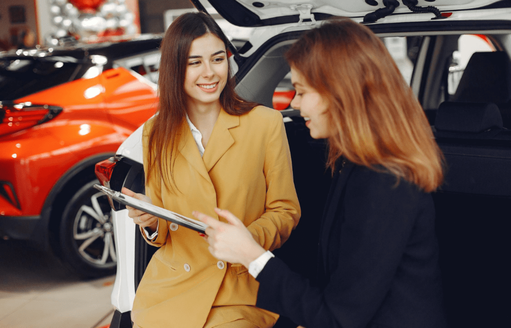 A sales associate showing a warranty form to a customer