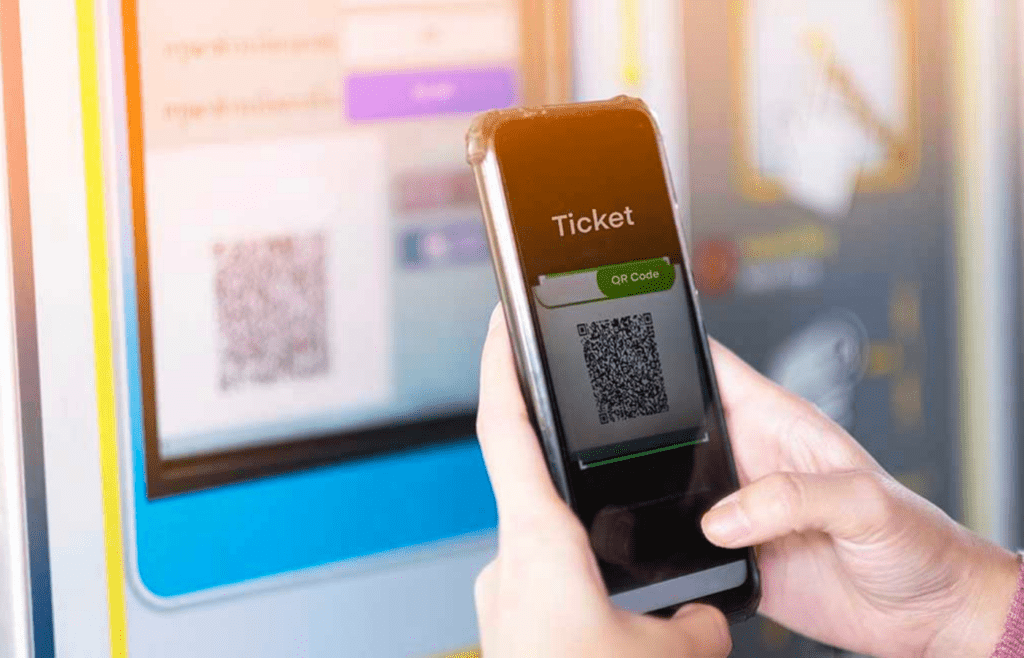 A mobile phone showing an online ticket purchase with added fees