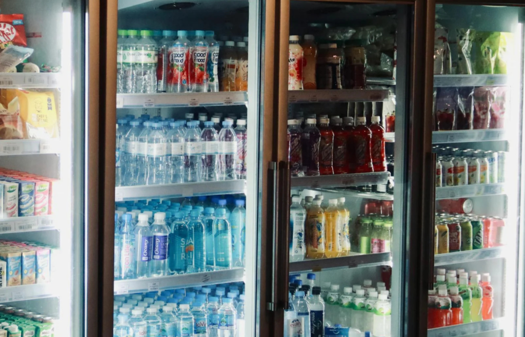 A fridge shelf filled with plastic water bottles