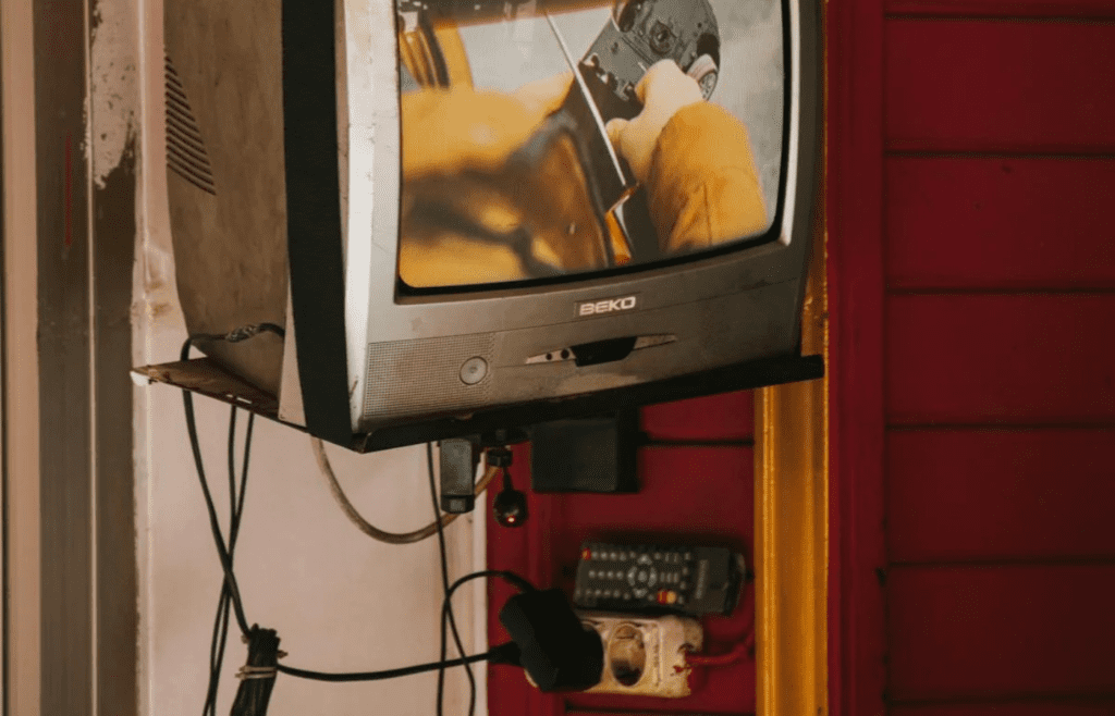 A bulky cable box under a television