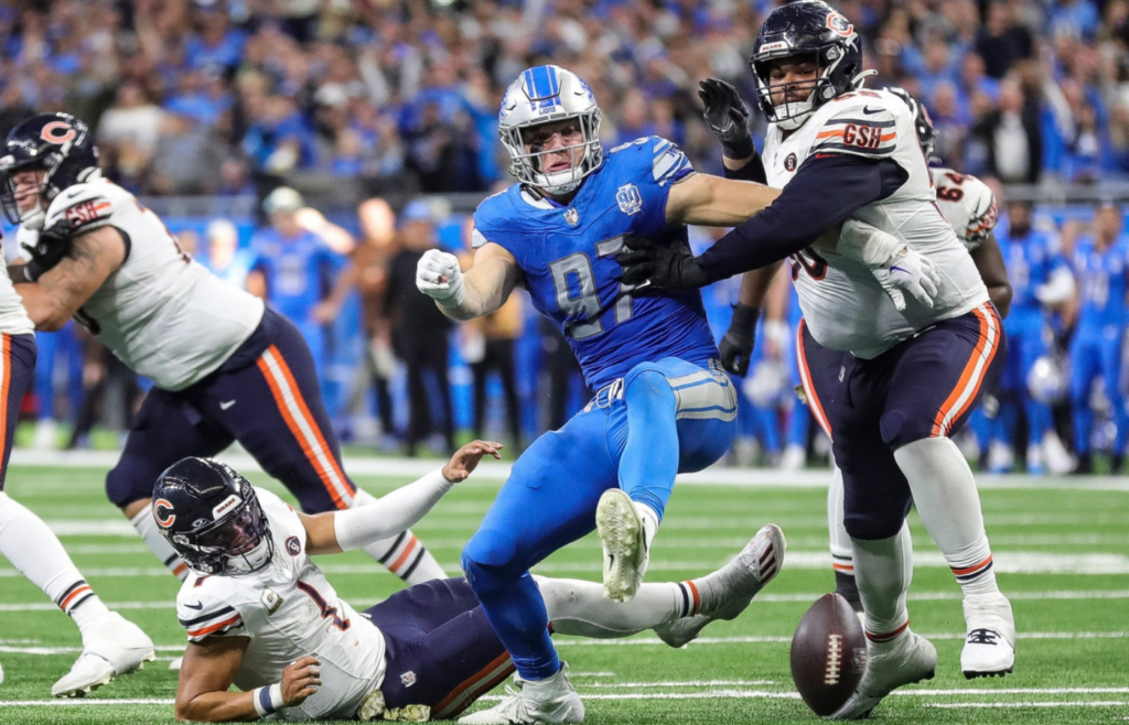 Detroit Lions defensive end Aidan Hutchinson (97) and Chicago Bears offensive tackle Darnell Wright (58) battle for the ball after Chicago Bears quarterback Justin Fields (1) is forced to fumble by Hutchinson during the second half at Ford Field in Detroit on Sunday, Nov. 19, 2023