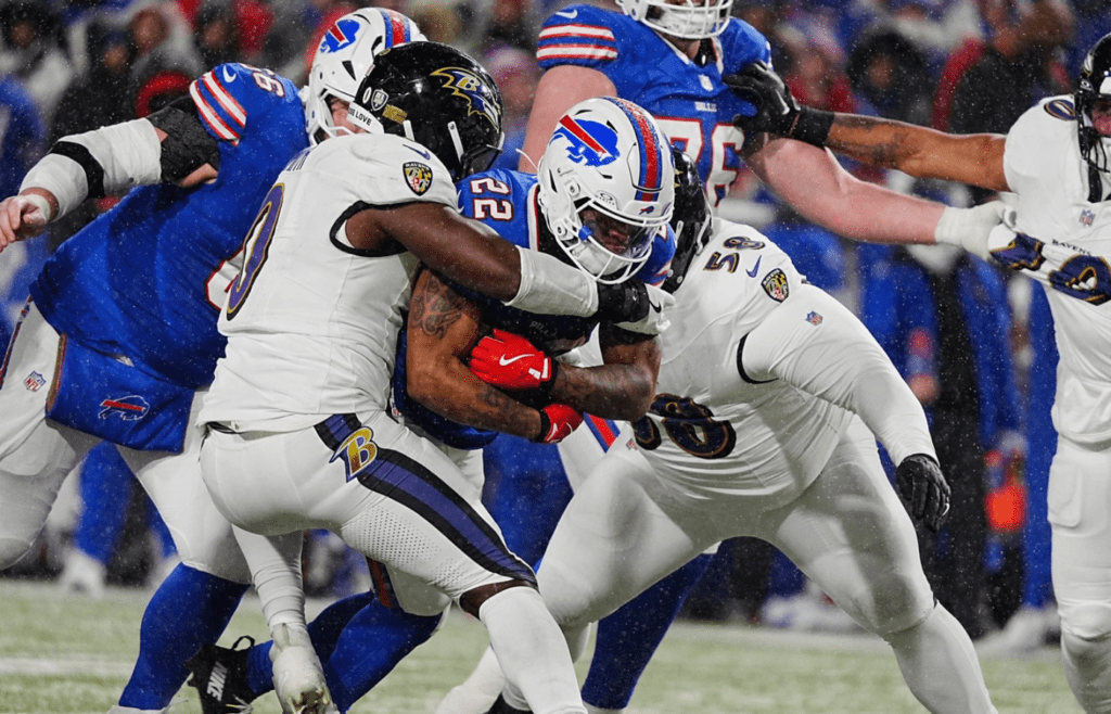 Baltimore Ravens linebacker Roquan Smith and Baltimore Ravens defensive tackle Michael Pierce wrap up Buffalo Bills running back Ray Davis during second half action at the Buffalo Bills divisional game against the Baltimore Ravens at Highmark Stadium in Orchard Park on Jan. 19, 2025