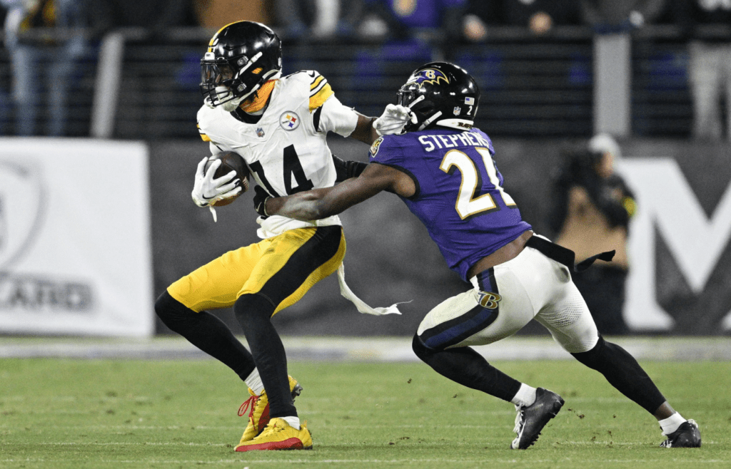 Jan 11, 2025; Baltimore, Maryland, USA; Pittsburgh Steelers wide receiver George Pickens (14) runs against Baltimore Ravens cornerback Brandon Stephens (21) in the fourth quarter in an AFC wild card game at M&T Bank Stadium. Mandatory Credit: Tommy Gilligan-Imagn Images