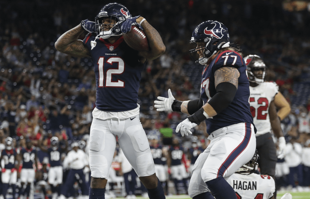 Aug 28, 2021; Houston, Texas, USA; Houston Texans wide receiver Donte Moncrief (12) celebrates after scoring a touchdown during the third quarter against the Tampa Bay Buccaneers at NRG Stadium. Mandatory Credit: Troy Taormina-Imagn Images