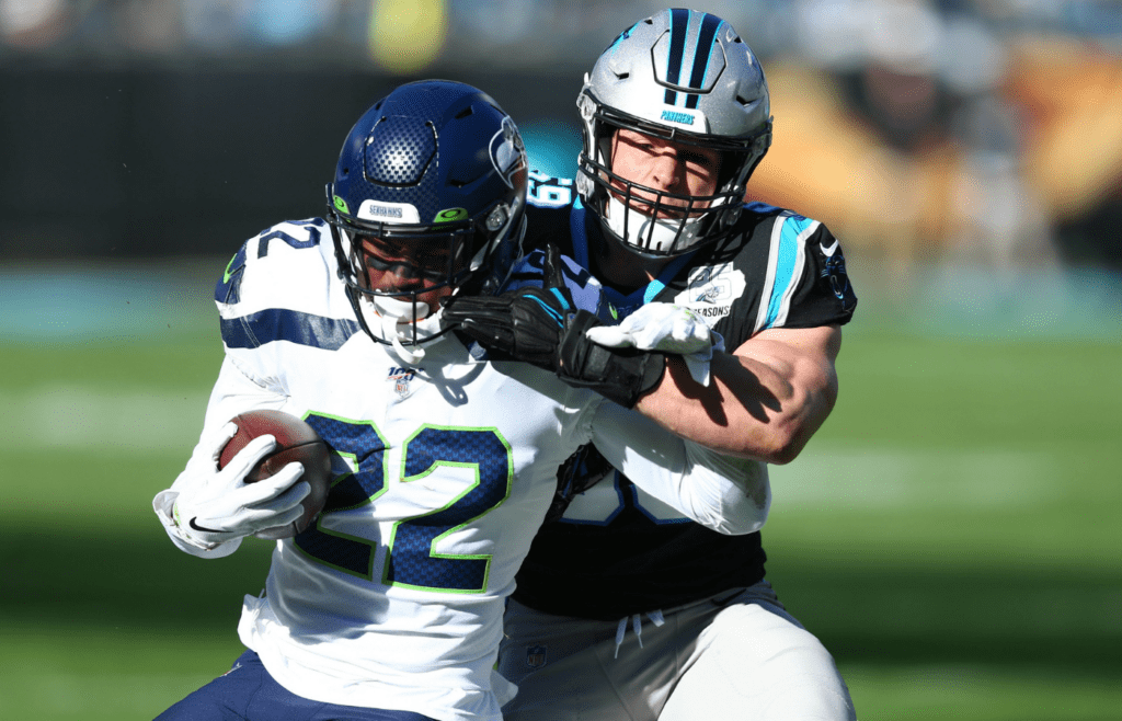 Dec 15, 2019; Charlotte, NC, USA; Carolina Panthers middle linebacker Luke Kuechly (59) pushes Seattle Seahawks running back C.J. Prosise (22) out of bounds during the first quarter at Bank of America Stadium. Mandatory Credit: Jeremy Brevard-Imagn Images