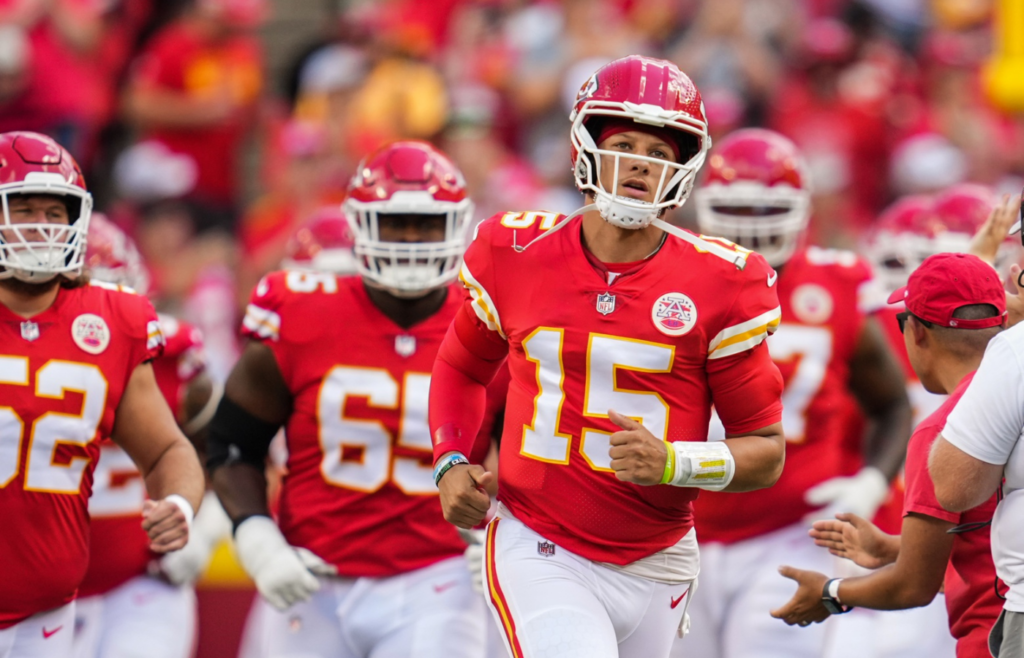 Aug 20, 2022; Kansas City, Missouri, USA; Kansas City Chiefs quarterback Patrick Mahomes (15) leads the team onto the field prior to a game against the Washington Commanders at GEHA Field at Arrowhead Stadium. Mandatory Credit: Jay Biggerstaff-Imagn Images
