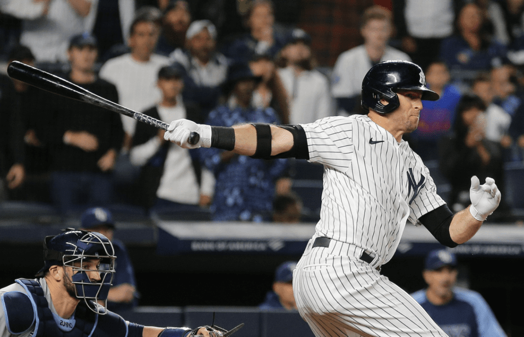 New York Yankees center fielder Brett Gardner (11) hits a RBI single against the Tampa Bay Rays during the ninth inning at Yankee Stadium.