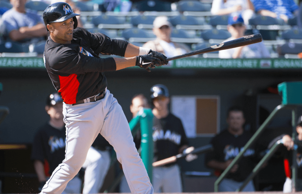 Feb 28, 2013; St. Louis, MO, USA; Miami Marlins third baseman Placido Polanco (30) puts the ball in play against the St. Louis Cardinals at Roger Dean Stadium. The Cardinals defeated the Marlins 8-2. Mandatory Credit: Scott Rovak-Imagn