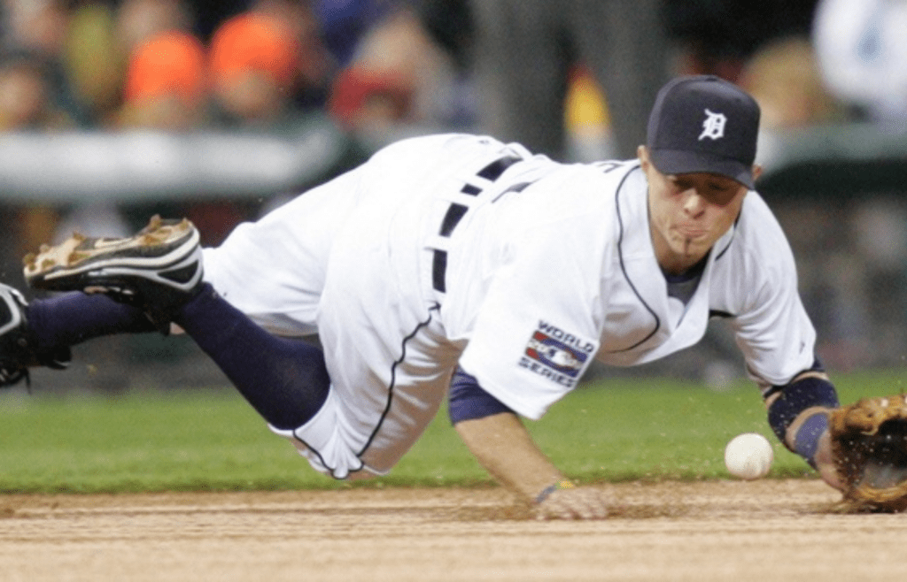 Detroit Tigers' Brandon Inge dives for the ball but cannot handle the ball hit by Scott Rolen in the first inning of Game 2 of the World Series against the St. Louis Cardinals at Comerica Park in Detroit, Sunday, Oct. 22, 2006