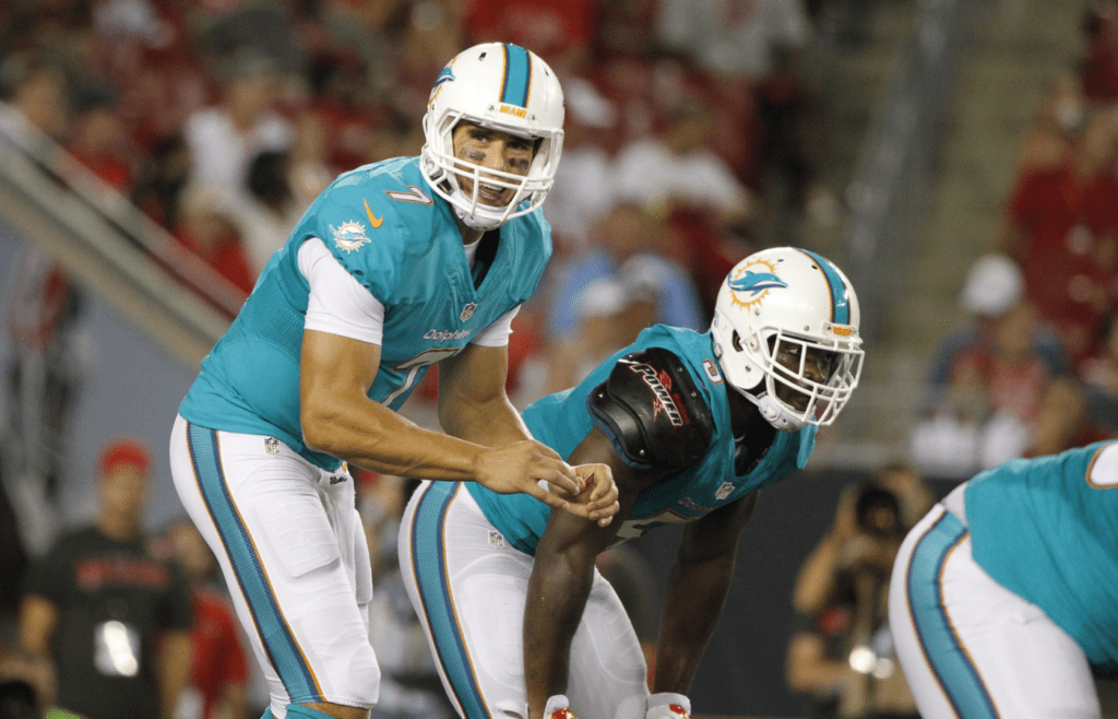 Aug 16, 2014; Tampa, FL, USA; Miami Dolphins quarterback Brady Quinn (7) calls a play during the second half against the Tampa Bay Buccaneers at Raymond James Stadium. Miami won 20-14. Mandatory Credit: Kim Klement-Imagn Images