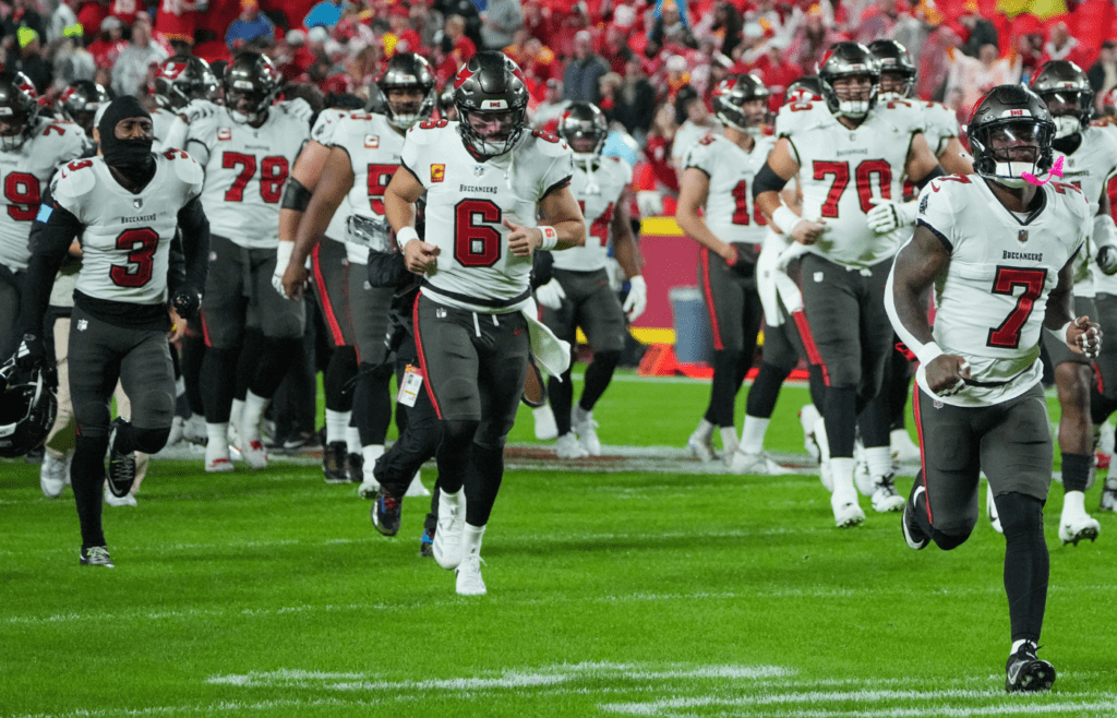 Nov 4, 2024; Kansas City, Missouri, USA; Tampa Bay Buccaneers quarterback Baker Mayfield (6), running back Bucky Irving (7) and team mates take the field against the Kansas City Chiefs prior to a game at GEHA Field at Arrowhead Stadium. Mandatory Credit: Denny Medley-Imagn Images