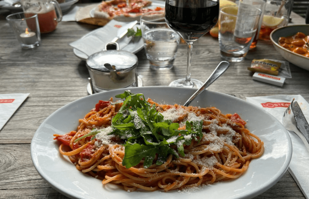 Pasta displayed next to sauce and cheese