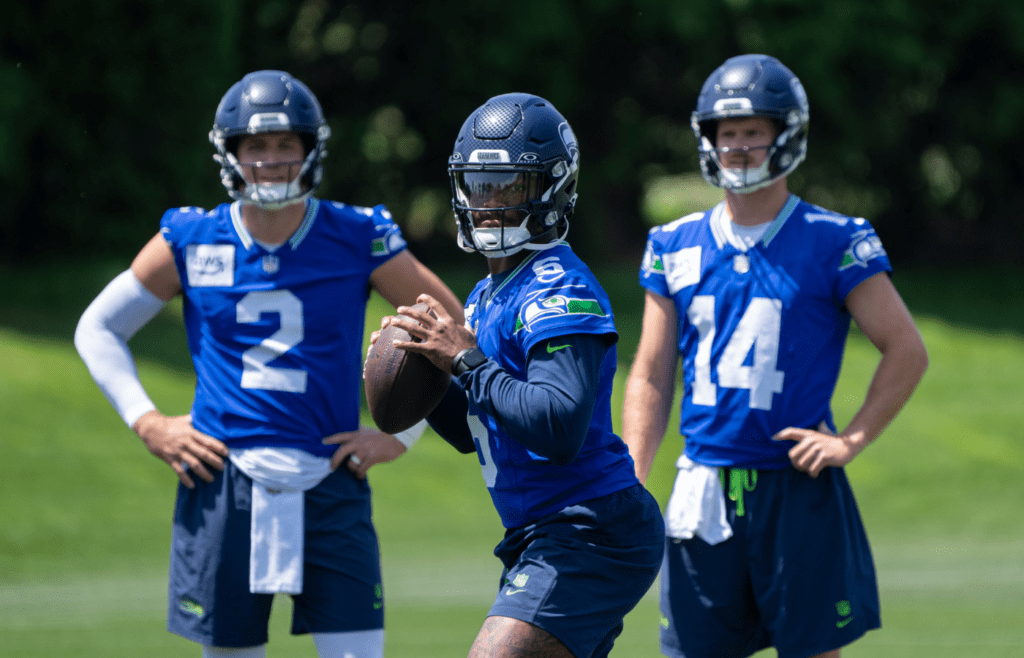Jun 11, 2025; Renton, WA, USA; Seattle Seahawks quarterback Jalen Milroe (6) looks to pass as quarterback Drew Lock (2) and quarterback Sam Darnold (14) during mini-camp at Virginia Mason Athletic Center. Mandatory Credit: Stephen Brashear-Imagn Images