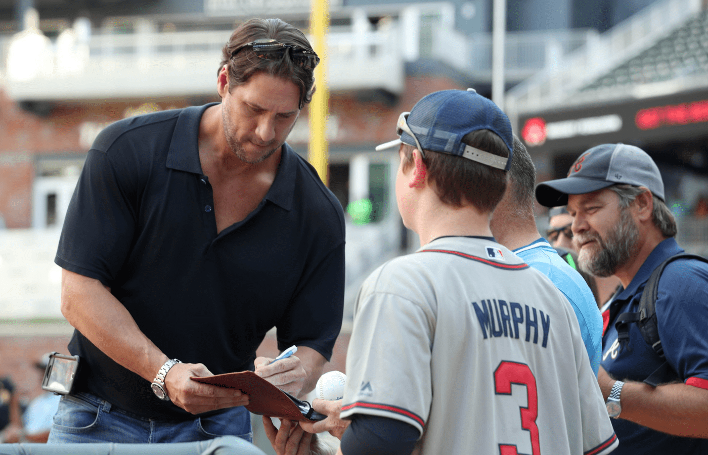 Jun 9, 2017; Atlanta, GA, USA; Atlanta Braves former relief pitcher John Rocker signs autographs for fans before the Braves game against the New York Mets at SunTrust Park. Mandatory Credit: Jason Getz-Imagn Images