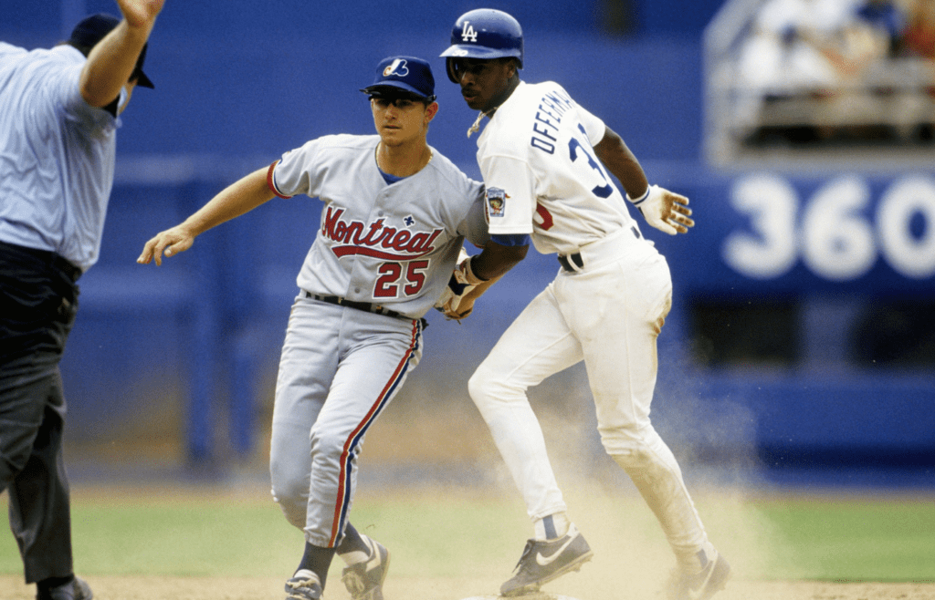 Jul 7, 1992, USA; FILE PHOTO; Montreal Expos infielder Bret Barberie (25) tags Los Angeles Dodgers base runner Jose Offerman (30) as Offerman slides into 2nd base safely at Dodger Stadium. Mandatory Credit: Imagn Images
