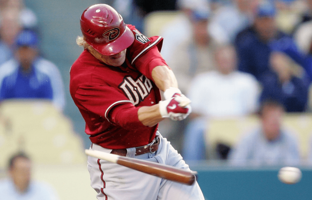 June 2, 2009; Los Angeles, CA, USA; Arizona Diamondbacks left fielder Eric Byrnes (22) breaks his bat as he hits a single in the first inning against the Los Angeles Dodgers at Dodger Stadium. Mandatory Credit: Gary A. Vasquez-Imagn Images