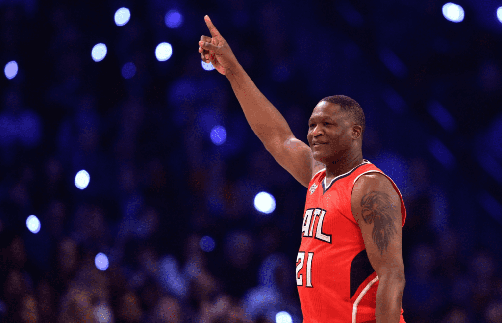 Feb 14, 2015; New York, NY, USA; Team Bosh legend Dominique Wilkins celebrates after winning the 2015 NBA All Star Shooting Stars competition at Barclays Center. Mandatory Credit: Bob Donnan-Imagn Images