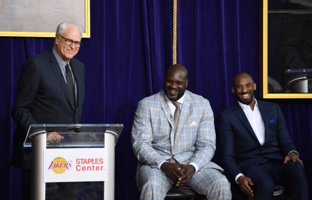 Mar 24, 2017; Los Angeles, CA, USA; Phil Jackson (left) speaks during ceremony to unveil statue of Los Angeles Lakers former center Shaquille ONeal (center) as Kobe Bryant (right) listens at Staples Center. Mandatory Credit: Kirby Lee-Imagn Images