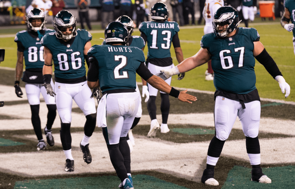 Jan 3, 2021; Philadelphia, Pennsylvania, USA; Philadelphia Eagles quarterback Jalen Hurts (2) celebrates with teammates after a touchdown run against the Washington Football Team during the second quarter at Lincoln Financial Field. Mandatory Credit: Bill Streicher-Imagn Images
