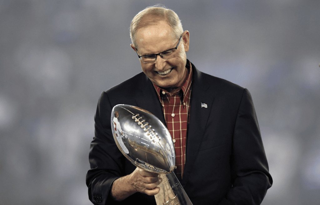 New York Giants former head coach head coach Tom Coughlin holds the Vince Lombardi Trophy from Super Bowl XLII during the halftime ceremony in the game against the Detroit Lions at MetLife Stadium.