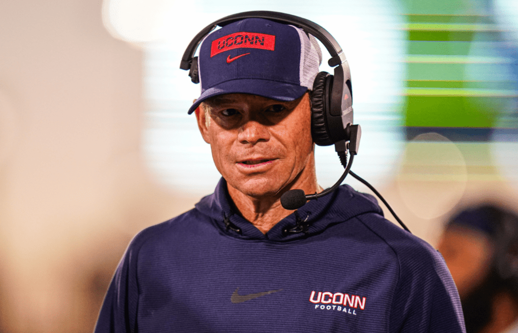 Connecticut Huskies head coach Jim Mora watches from the sideline as they take on the Rice Owls at Rentschler Field at Pratt & Whitney Stadium