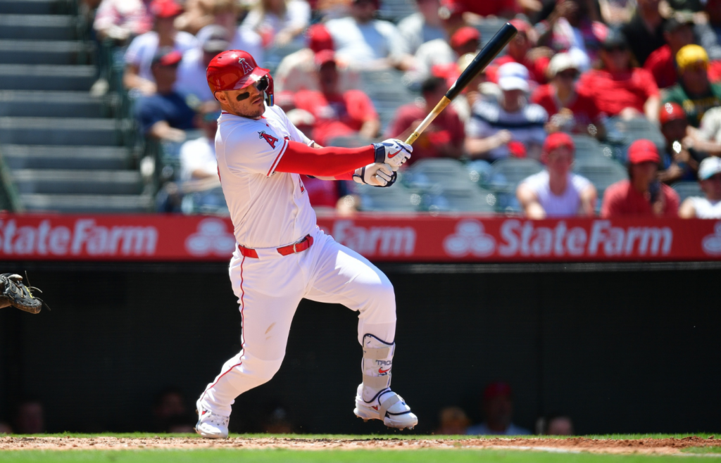 Jun 11, 2025; Anaheim, California, USA; Los Angeles Angels designated hitter Mike Trout (27) hits a single against the Athletics during the fourth inning at Angel Stadium. Mandatory Credit: Gary A. Vasquez-Imagn Images