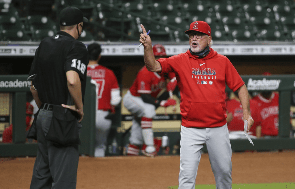 Aug 25, 2020; Houston, Texas, USA; Los Angeles Angels manager Joe Maddon argues with home plate umpire Clint Vondrak after being ejected during the sixth inning against the Houston Astros in game 2 of a double header at Minute Maid Park. Mandatory Credit: Troy Taormina-Imagn Images