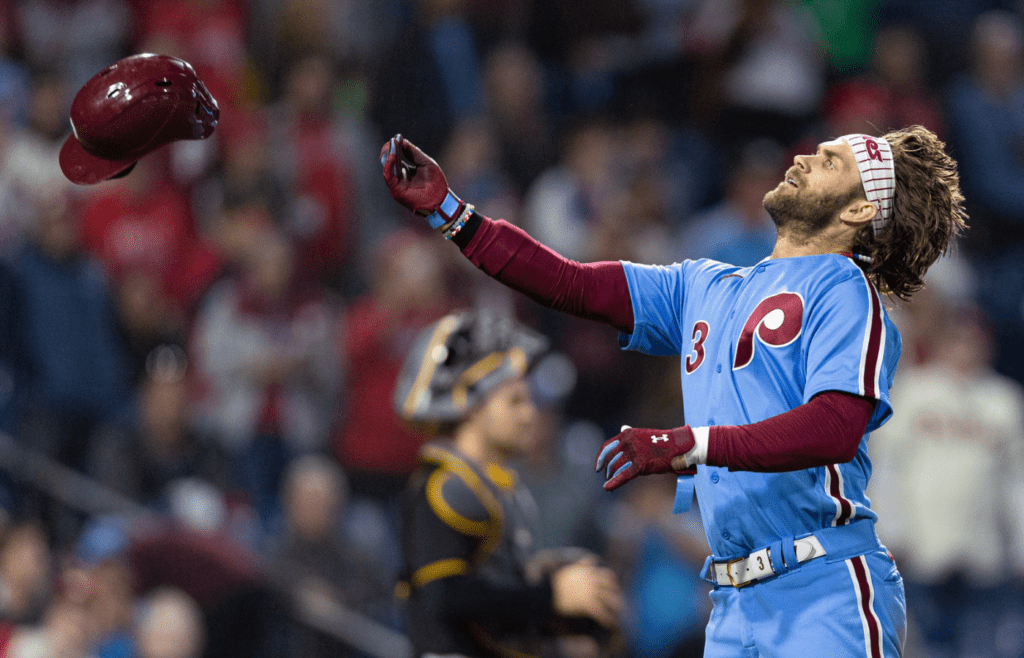 Sep 28, 2023; Philadelphia, Pennsylvania, USA; Philadelphia Phillies designated hitter Bryce Harper (3) throws his helmet into the stands after being ejected for arguing a strike call with umpire Angel Hernandez during the third inning of a game against the Pittsburgh Pirates at Citizens Bank Park. Mandatory Credit: Bill Streicher-Imagn Images