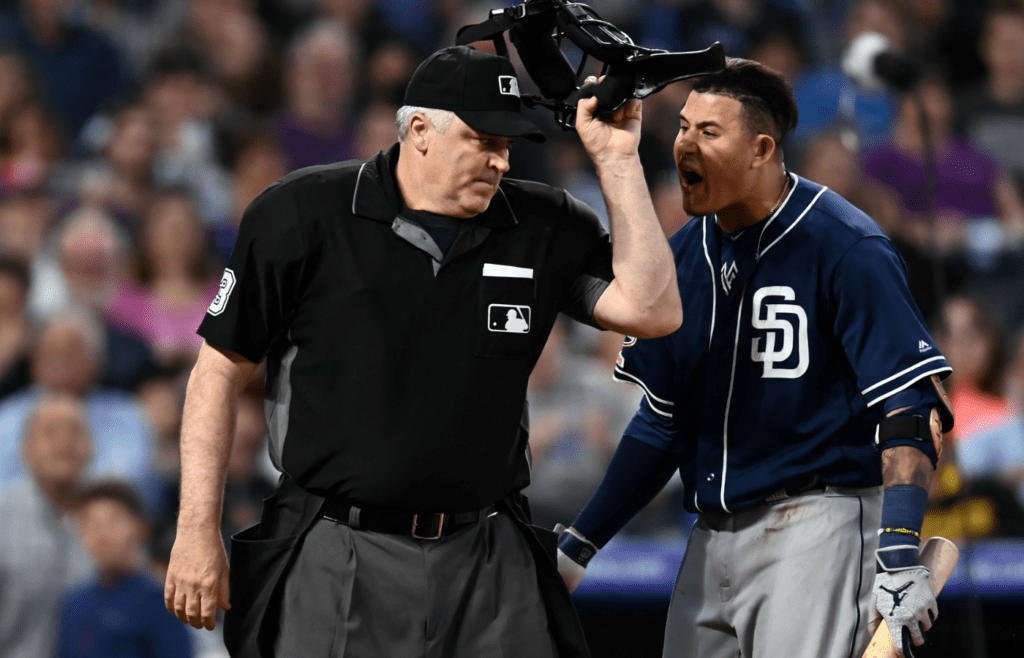 Jun 15, 2019; Denver, CO, USA; MLB home plate umpire Bill Welke (3) ejects and San Diego Padres shortstop Manny Machado (13) during the fifth inning against the Colorado Rockies at Coors Field. Mandatory Credit: Ron Chenoy-Imagn Images