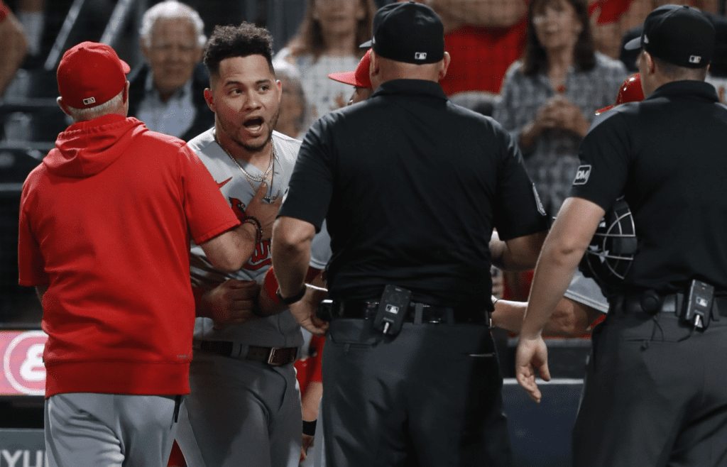 Aug 22, 2023; Pittsburgh, Pennsylvania, USA; St. Louis Cardinals catcher Willson Contreras (left middle) is restrained as he yells at home plate umpire Brennan Miller (right) as crew chief Mark Carlson (middle) listens in after Contreras was ejected from the game against the Pittsburgh Pirates during the seventh inning at PNC Park. Mandatory Credit: Charles LeClaire-Imagn Images