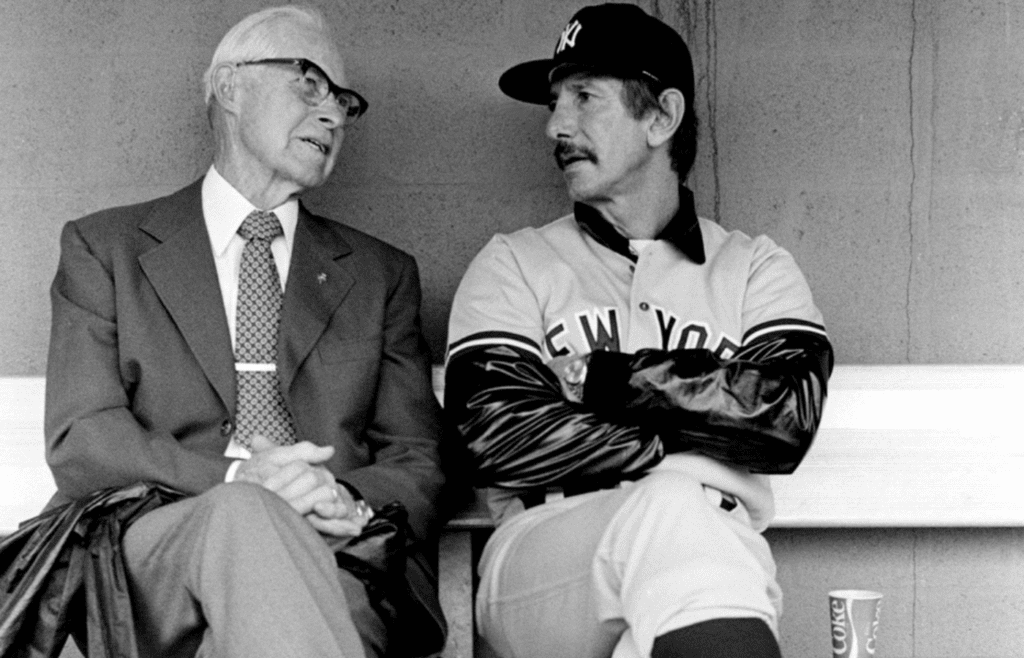New York Yankees manager Billy Martin, right, talks with friend Jim Turner of Nashville, in the dugout at Greer Stadium in Nashville April 28, 1983. The Yankees will play their Double A farm team, the Nashville Sounds