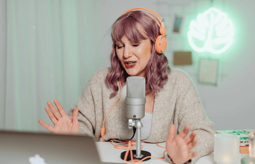 A student speaking into a microphone in a studio