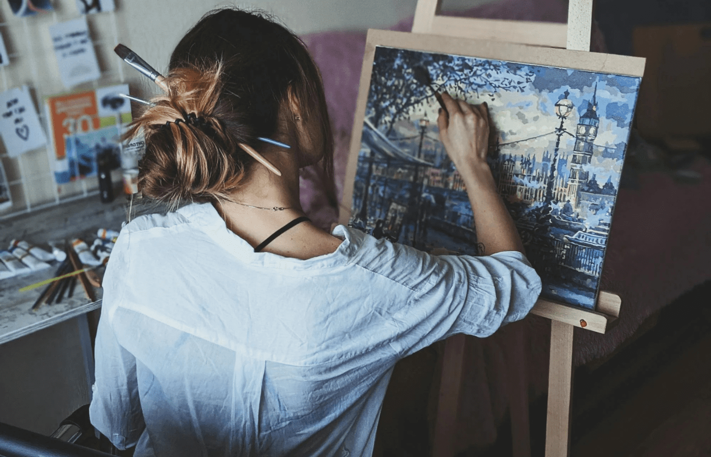 An artist painting in a studio