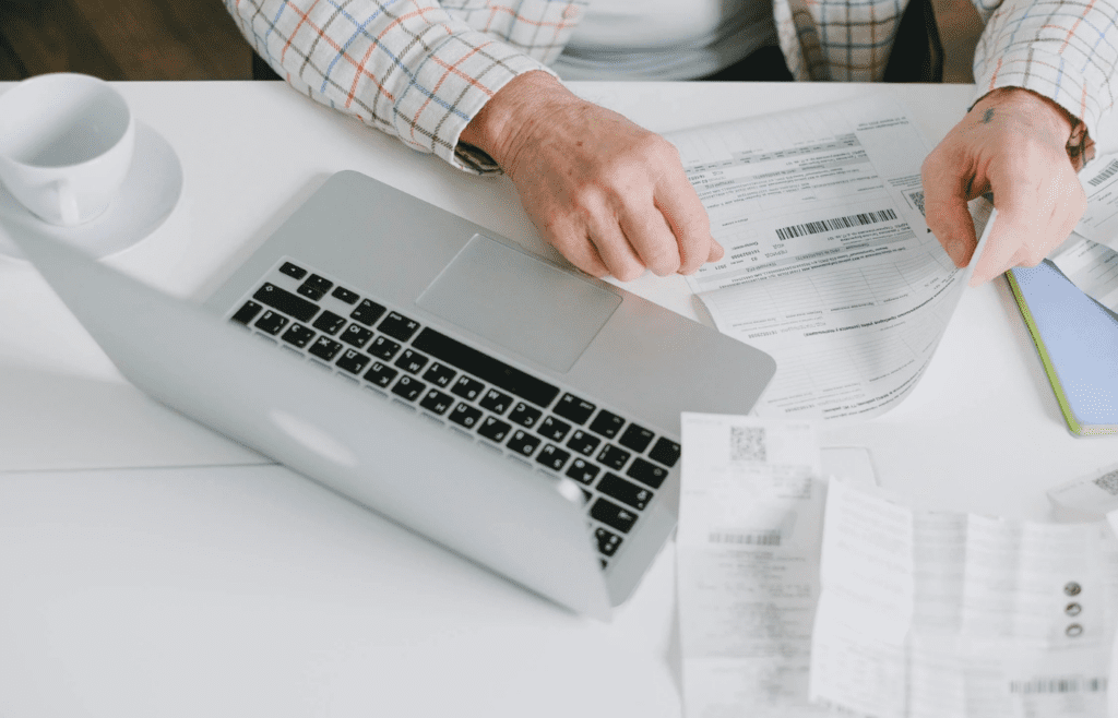 A cluttered desk with unorganized receipts