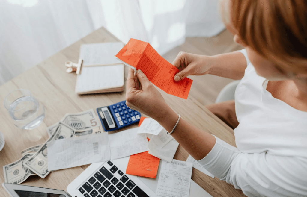 A person allocating money to bills before savings