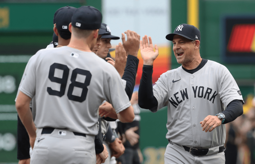 Apr 4, 2025; Pittsburgh, Pennsylvania, USA; New York Yankees manager Aaron Boone (17) greets his team during player introductions against the Pittsburgh Pirates n the 2025 Opening Day game at PNC Park. Mandatory Credit: Charles LeClaire-Imagn Images