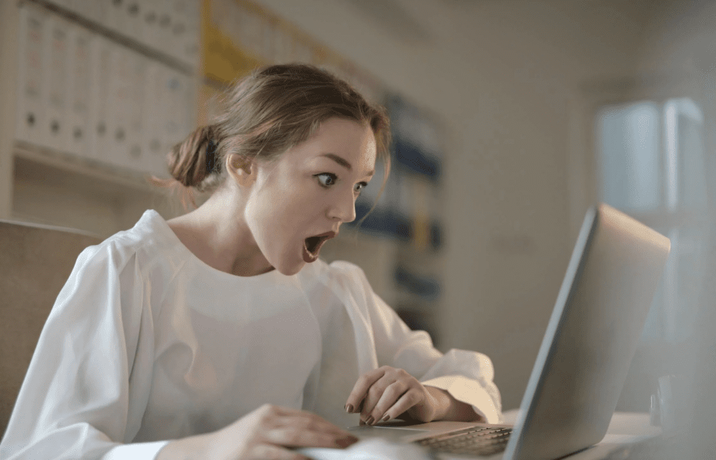 A person looking surprised while reading an email.