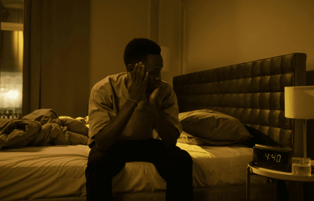 A person looking downcast while sitting alone