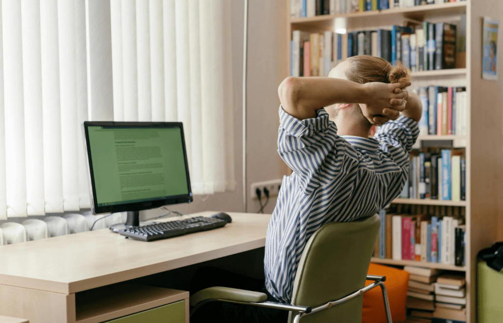 A young person looking amazed at a computer screen