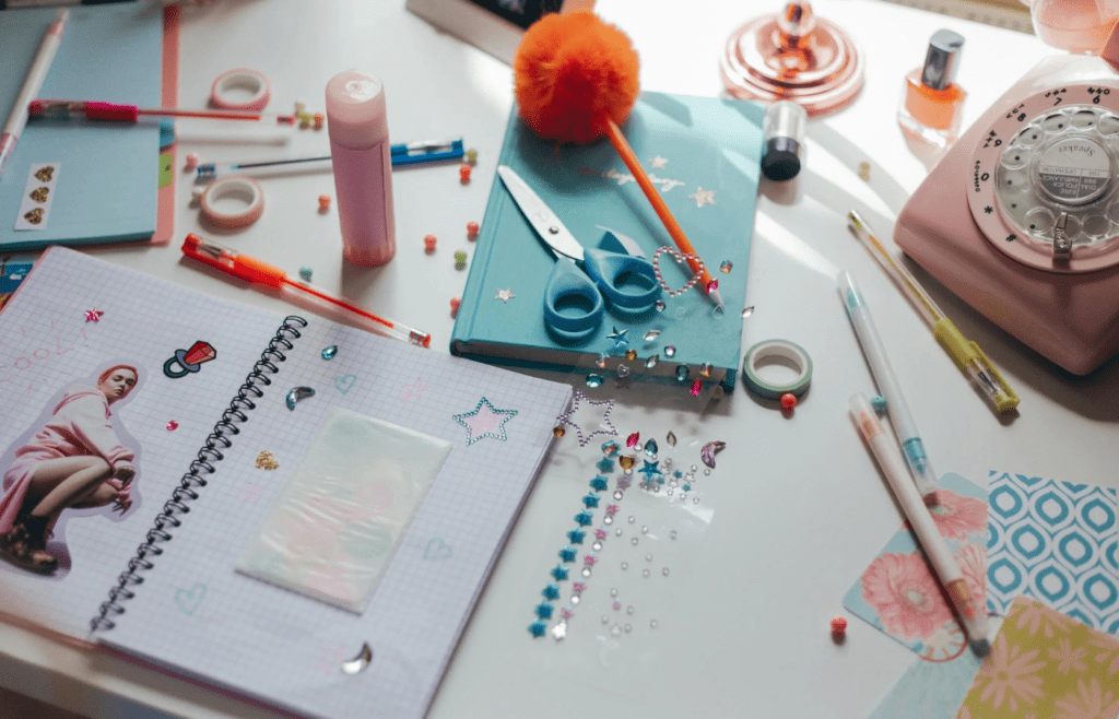 Crayons, glue, scissors, and folders on a table