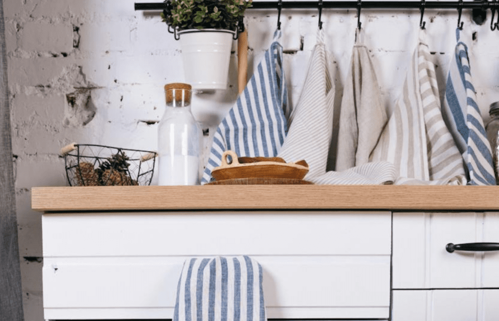 Bright dish towels hanging on a stove